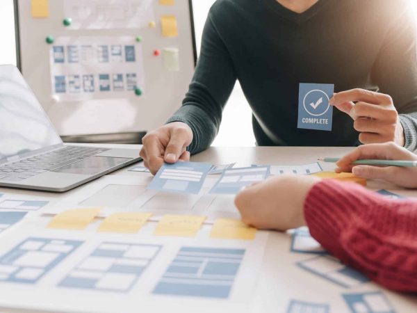 Brainstorming Group of people Working Concept. Business team brainstorming. Marketing plan researching. Paperwork on the table, laptop and mobile phone